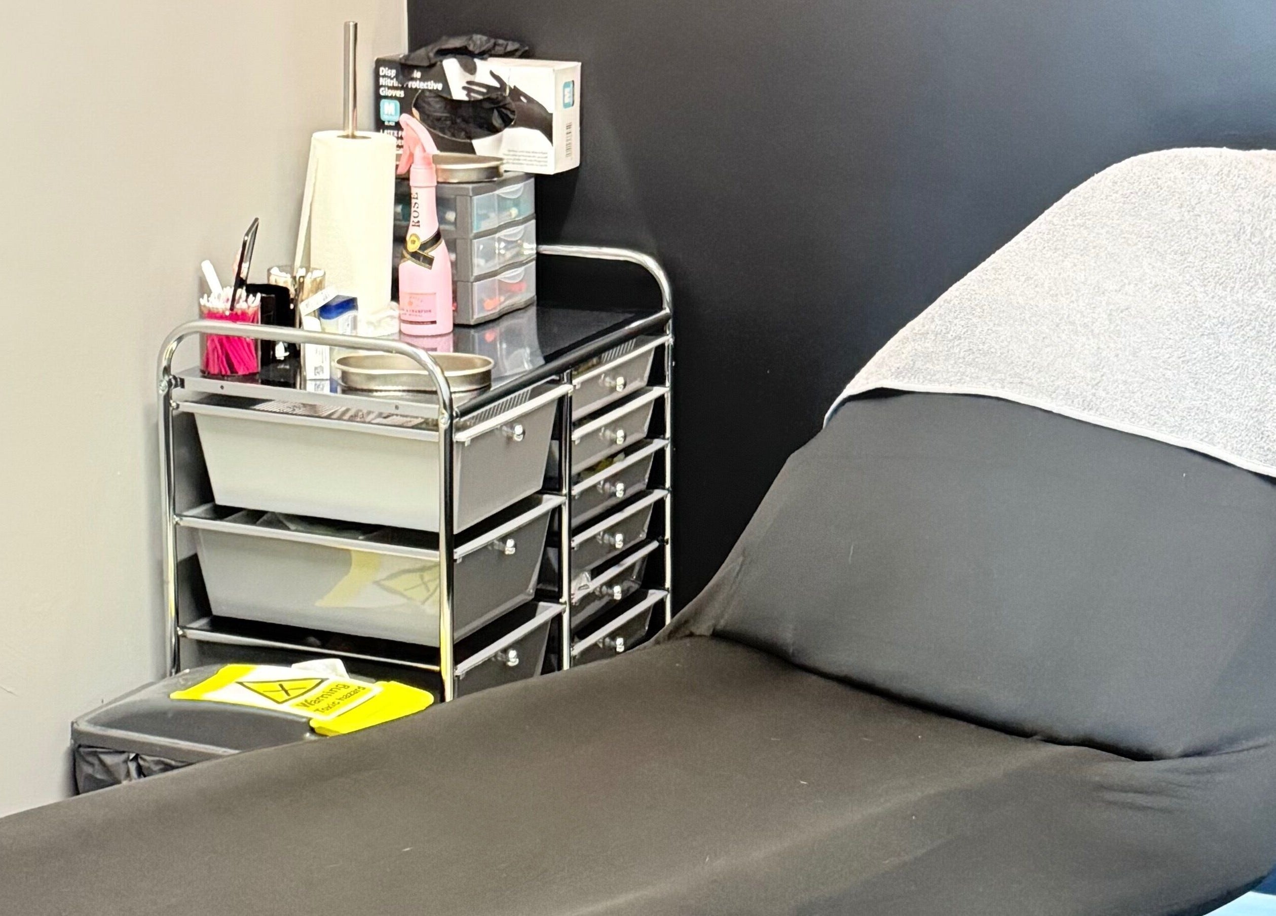 Comfortable treatment bed in serene AB Beauty, Newton Abbot, England, GB, ready for clients.