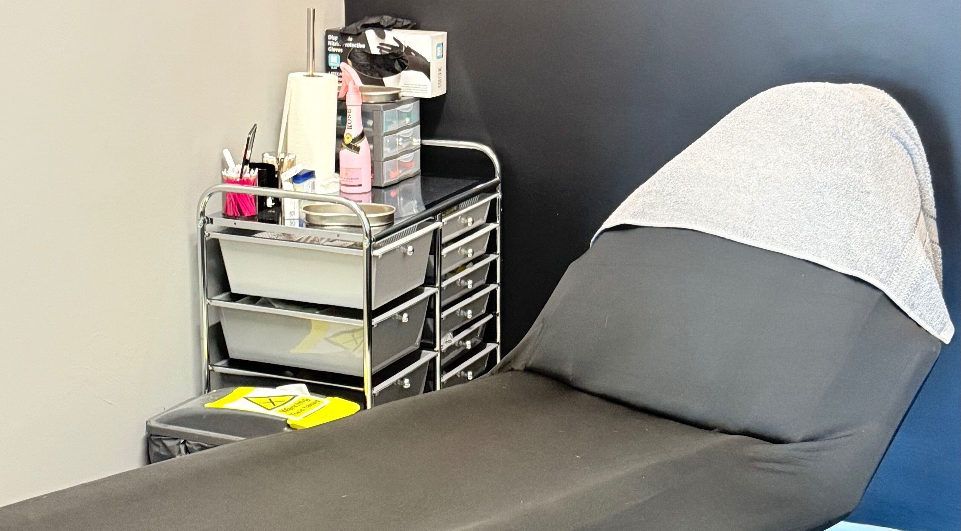 Comfortable treatment bed in serene AB Beauty, Newton Abbot, England, GB, ready for clients.