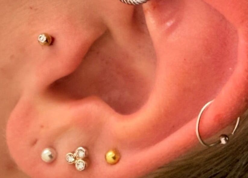 Multiple ear piercings displayed at AB Beauty, Newton Abbot, England, GB, offering unique style options.