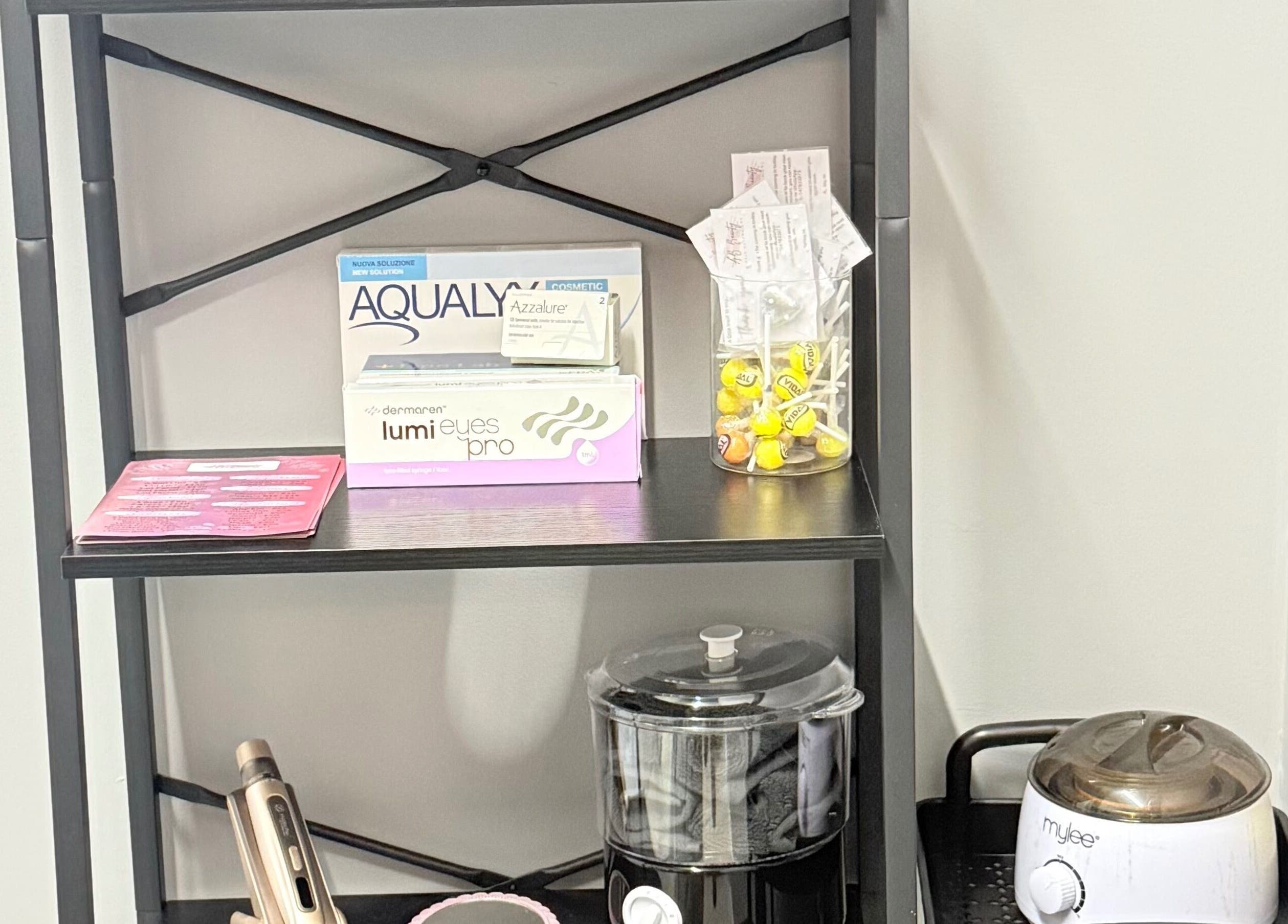 Beauty products and tools displayed on a shelf at AB Beauty in Newton Abbot, England, GB.