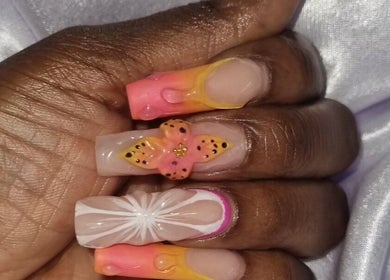 Colorful butterfly nail art at Neica Adore in Birmingham, England, GB. Close-up of creative manicure.