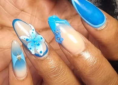 Intricate blue floral nail art at Neica Adore, Birmingham, England, GB showcasing elegant design.