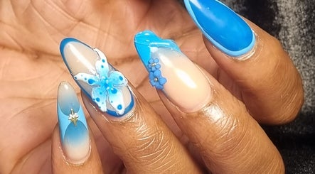 Intricate blue floral nail art at Neica Adore, Birmingham, England, GB showcasing elegant design.