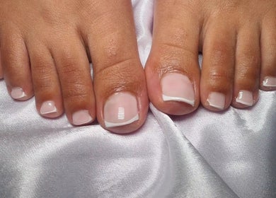 Beautiful French pedicure at Neica Adore, Birmingham, England, GB, showcasing shiny, well-groomed toenails.