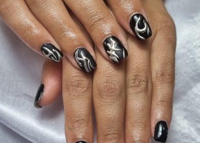 Chic black nails with silver art at Neica Adore, Birmingham, England, GB for stunning nail designs.
