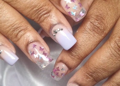Elegant nail art with butterfly decals at Neica Adore, Birmingham, England, GB.