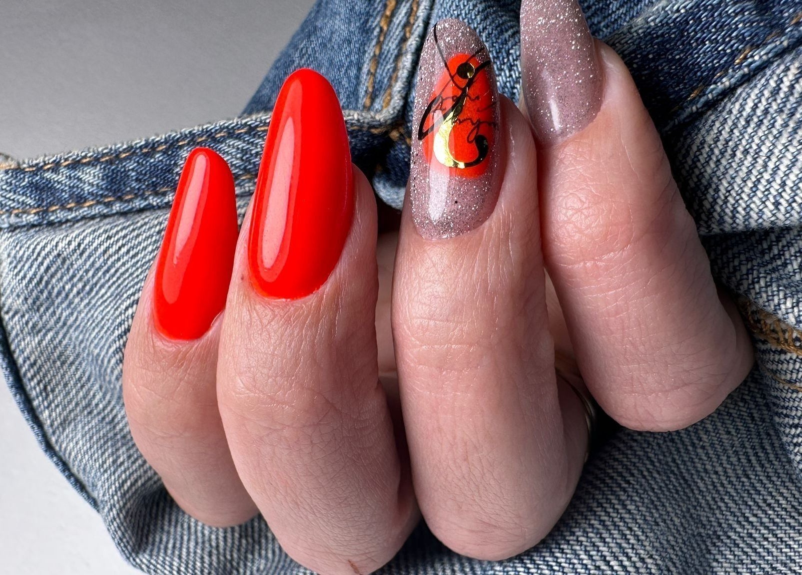 Bright nail art with glossy red and glitter designs at Nails by Amber, Heywood, England, GB.