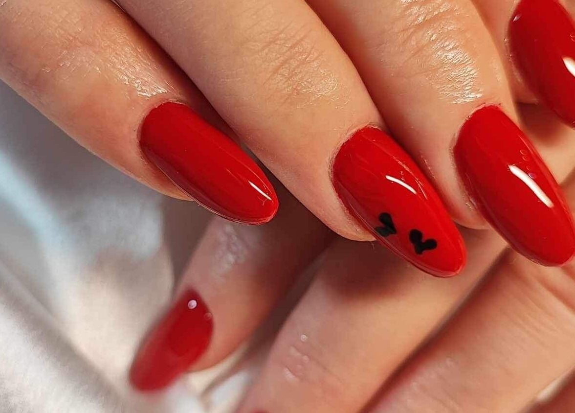 Elegant red manicure with heart detail at Nails by Amber, Heywood, England, GB.