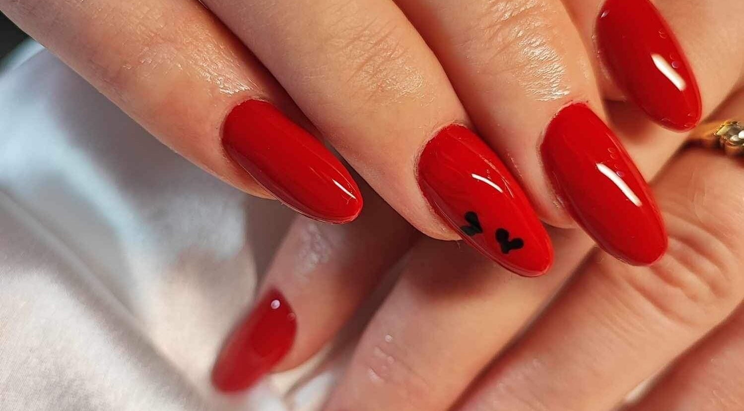 Elegant red manicure with heart detail at Nails by Amber, Heywood, England, GB.