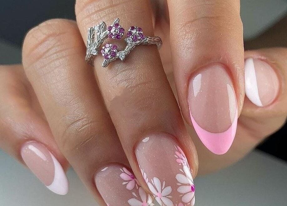 Elegant floral nail design at Nails by Amber, Heywood, England, GB, showcasing pink French tips and flower accents.