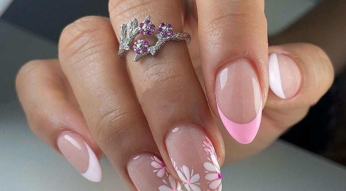 Elegant floral nail design at Nails by Amber, Heywood, England, GB, showcasing pink French tips and flower accents.