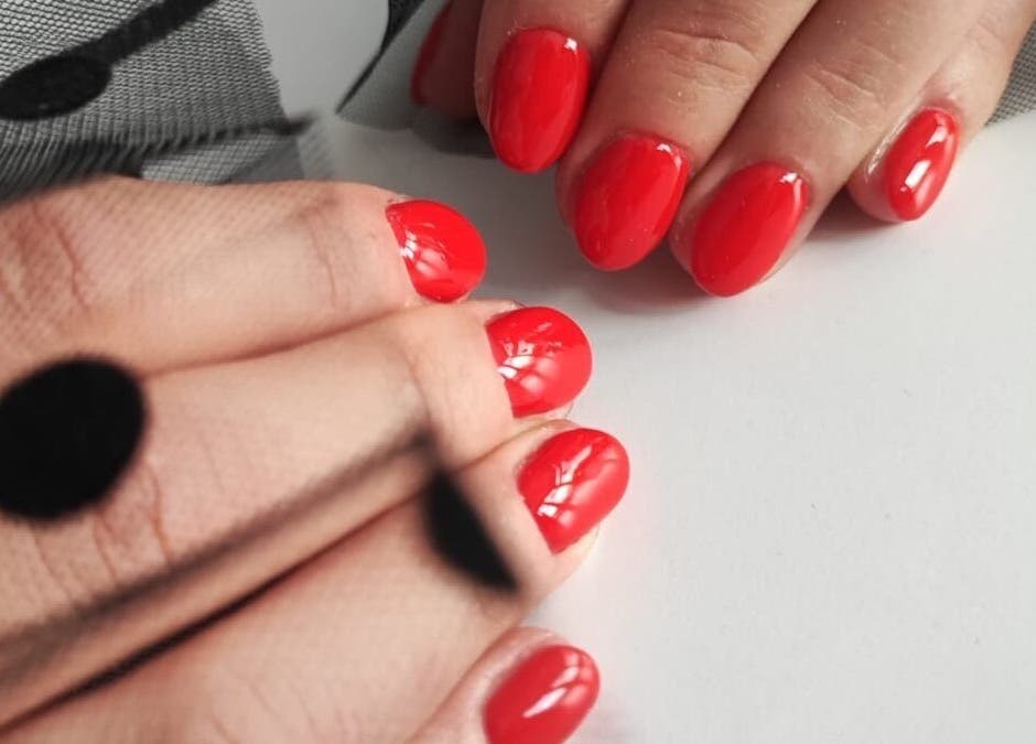 Glossy red nails with netting detail at Nails by Amber, Heywood, England, GB.