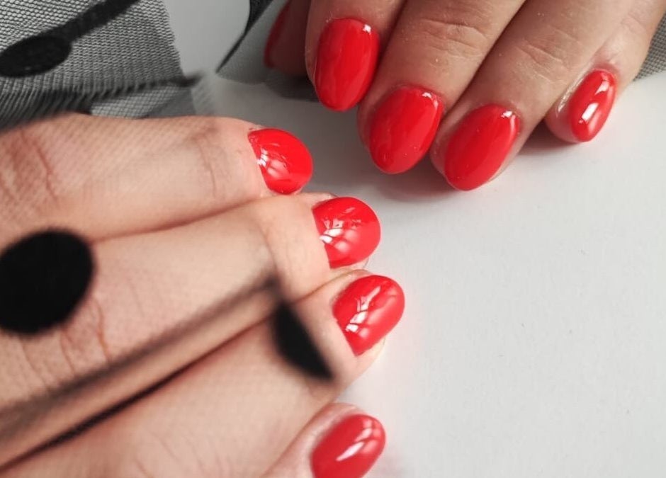 Glossy red nails with netting detail at Nails by Amber, Heywood, England, GB.