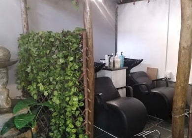 Calm wash area at Mint & Co Hair & Nails, Pietermaritzburg, Gauteng, ZA featuring serene greenery and modern chairs.