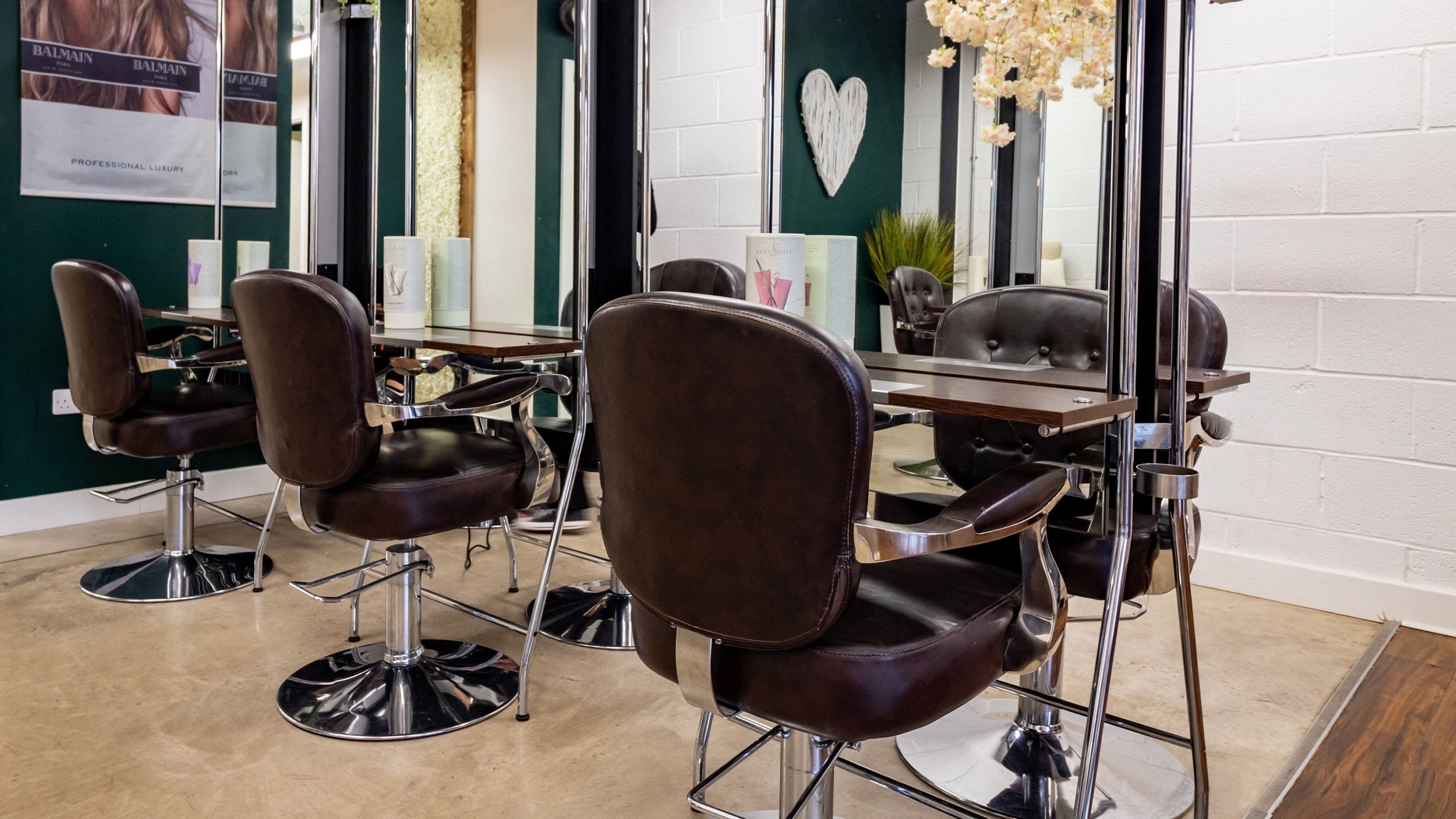 Stylish salon interior at VOIE Hair Garstang, Catterall, showcasing modern chairs and mirrors.
