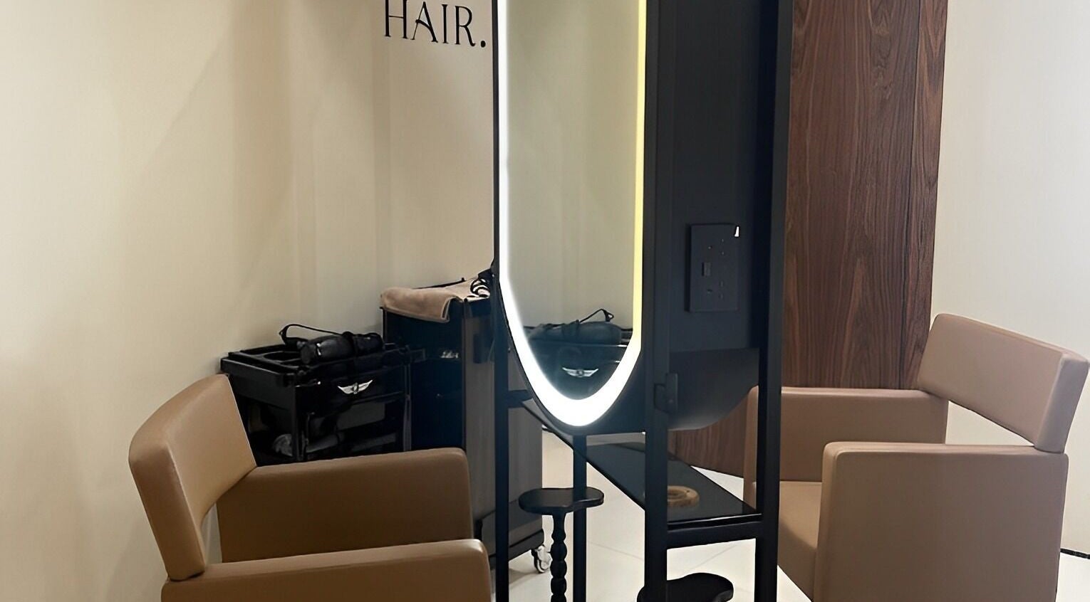 Elegant hair styling area with chairs and mirror at Oak Spa, Sharjah, Sharjah, AE.