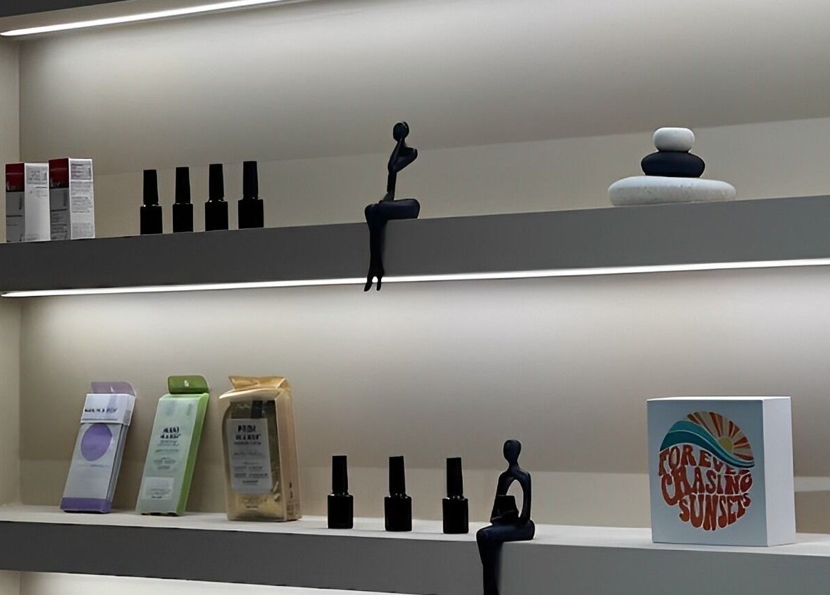 Sleek shelves at Oak Spa, Sharjah, Sharjah, AE, showcasing beauty products and elegant decor.