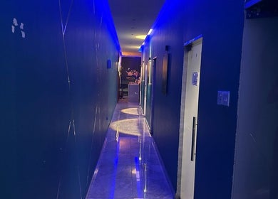 Modern corridor in AK SPA - Dammam, featuring blue lighting and sleek decor, located in Dammam, Eastern Province, SA.