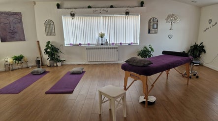 Peaceful massage room at Massage By Chloe, Southam, England, GB with yoga mats and treatment table.