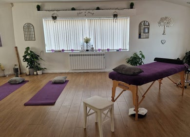 Tranquil room at Massage By Chloe in Southam, England, GB, featuring yoga mats and massage table.