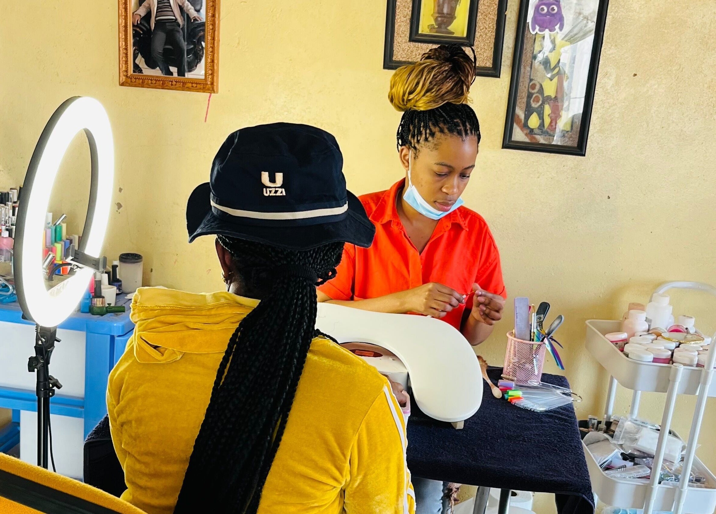 Nail technician working on client at Funky Nails By Sholo, Kuruman, South Africa, ZA with neat setup.
