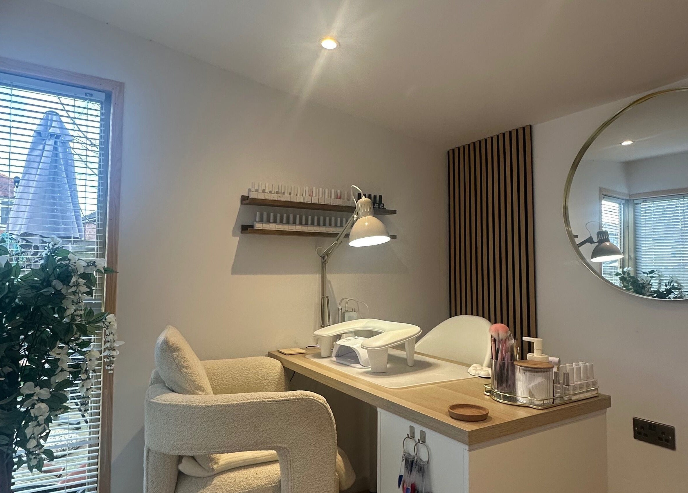 Bright nail station at The Nail Studio - By Beth Rudd, York, England, GB with a plush chair and modern decor.