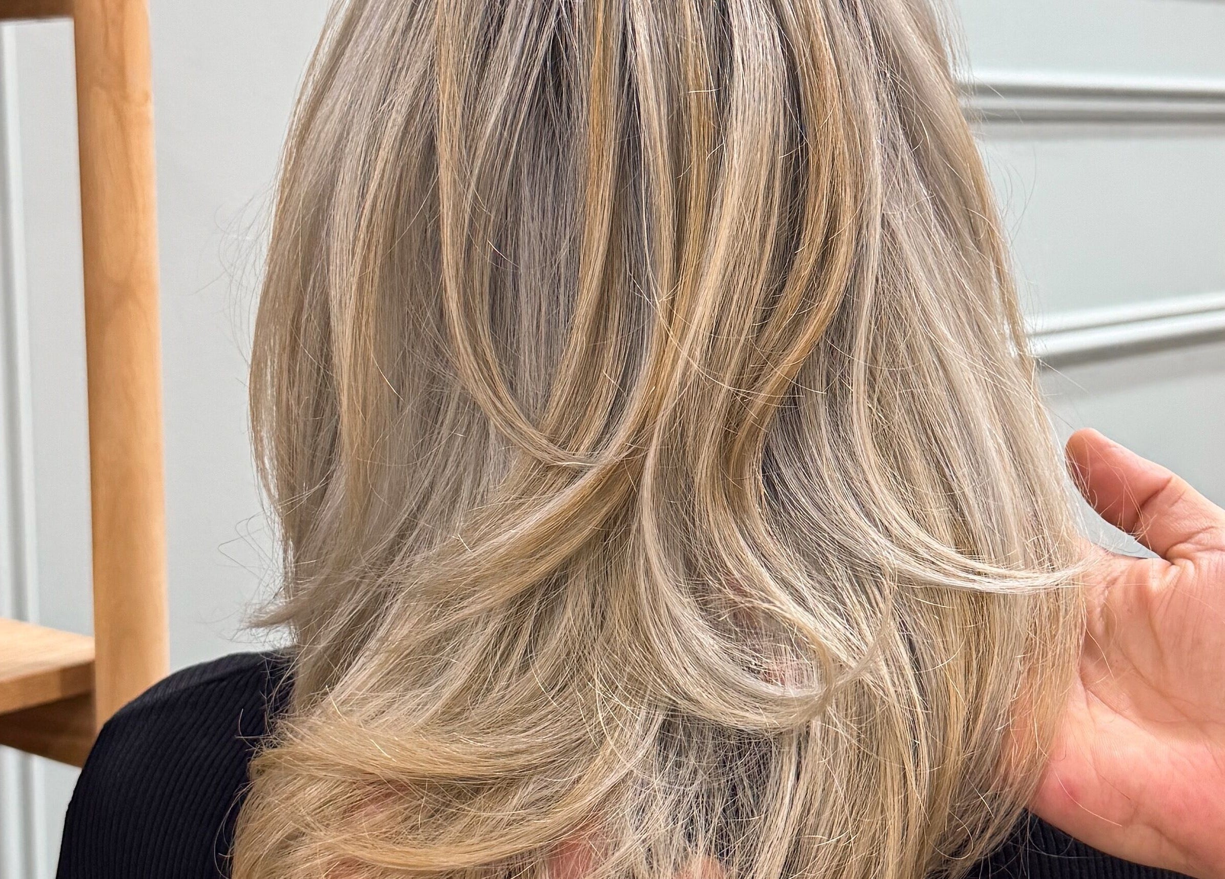 Elegant blonde hairstyle crafted at Hair Majesty, Riverton, Western Australia, AU, showcasing smooth waves.