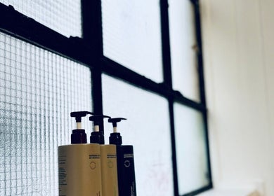 Luxury skincare products by a window at Abōde, Sydney, New South Wales, AU.