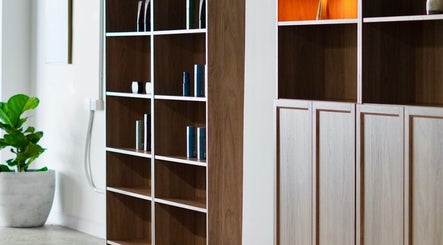 Stylish wooden shelves at Abōde, Sydney, New South Wales, AU, showcasing beauty products.