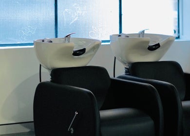 Elegant salon wash basins at Abōde, Sydney, New South Wales, AU, showcasing modern beauty services.