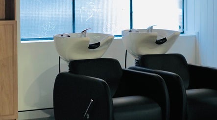 Elegant salon wash basins at Abōde, Sydney, New South Wales, AU, showcasing modern beauty services.