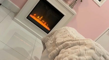 Warm fireplace setting at Fabulously Esthetics, Los Angeles, California, US offering comfort and relaxation.