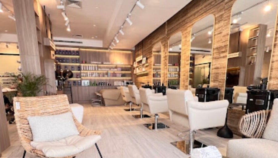 Elegant interior of Lola Ley | صالون لولالي, Riyadh featuring stylish seating, mirrors, and modern decor.