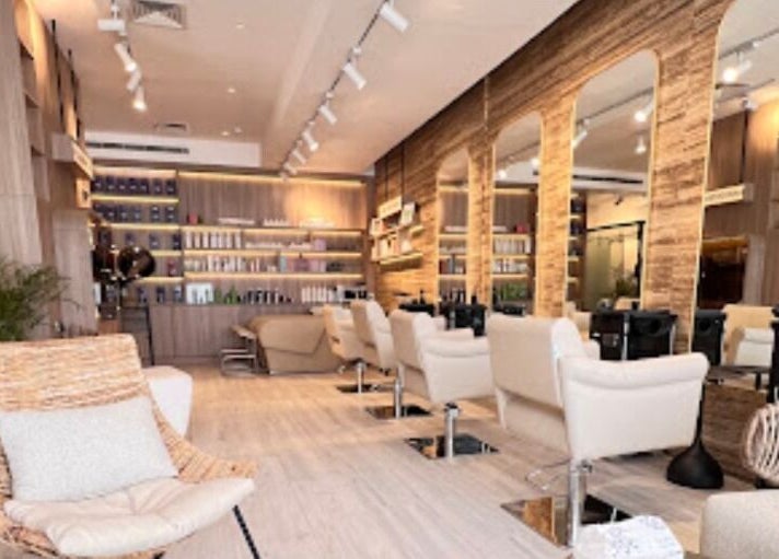 Elegant interior of Lola Ley | صالون لولالي, Riyadh featuring stylish seating, mirrors, and modern decor.