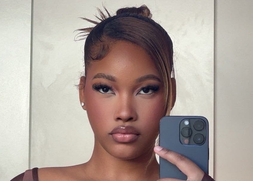 Woman with elegant lashes at Fairy Lashes, Cape Town, Western Cape, ZA, taking a stylish selfie.