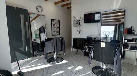 Modern interior of Binnom Hair salon in Newcastle upon Tyne, England, showcasing sleek chairs and mirrors.