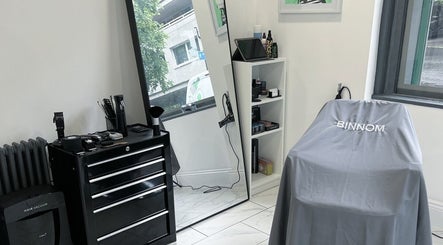 Modern salon interior at Binnom Hair, Newcastle upon Tyne, England, GB. Equipped with styling tools and mirrors.