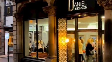 Eve Woods Hair in Harrogate, England, GB, showcasing a stylish, illuminated storefront with clients inside.