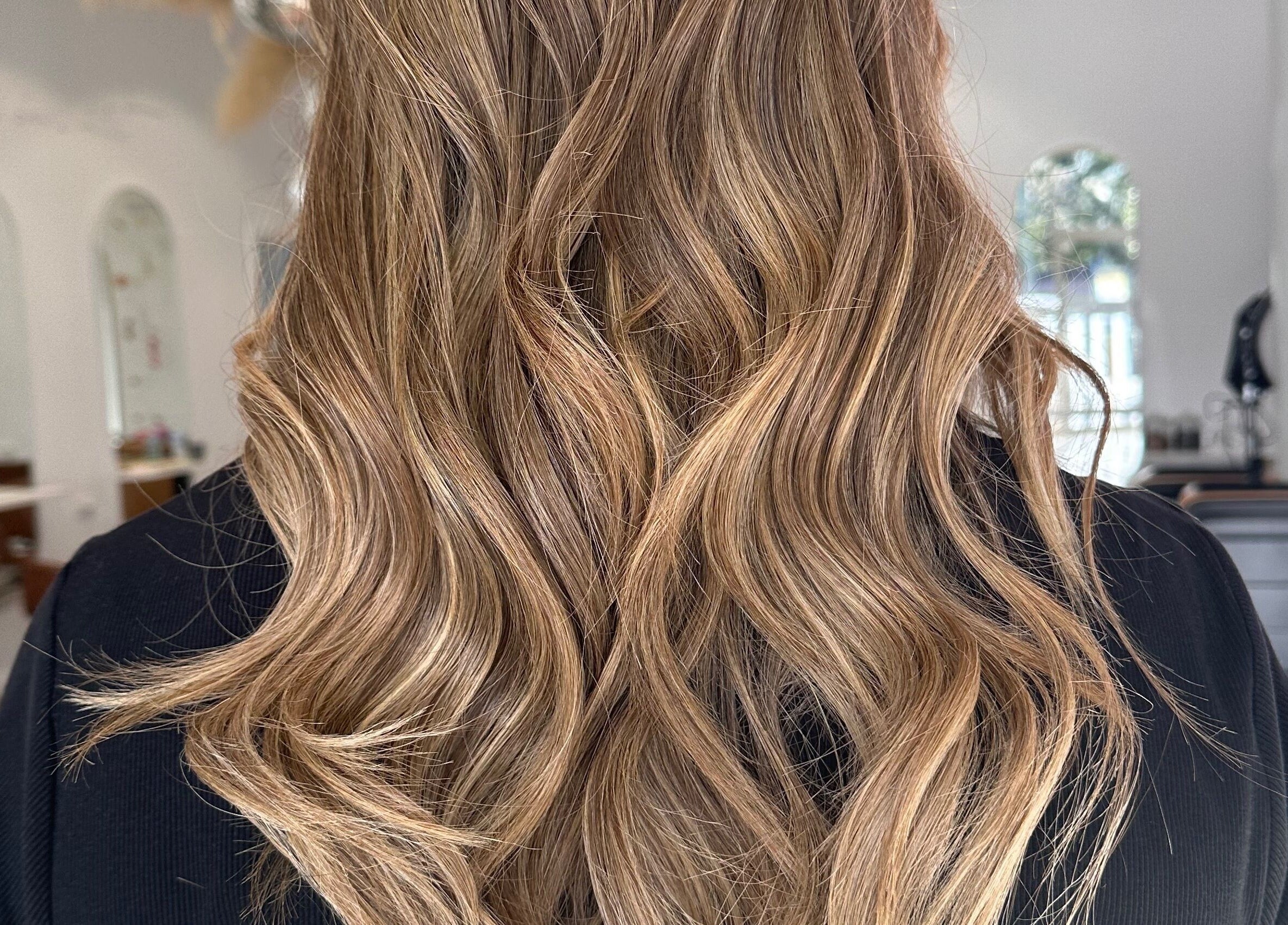 Lustrous golden wavy hairstyle at Hope at The Studio, Castle Hill, New South Wales, AU.
