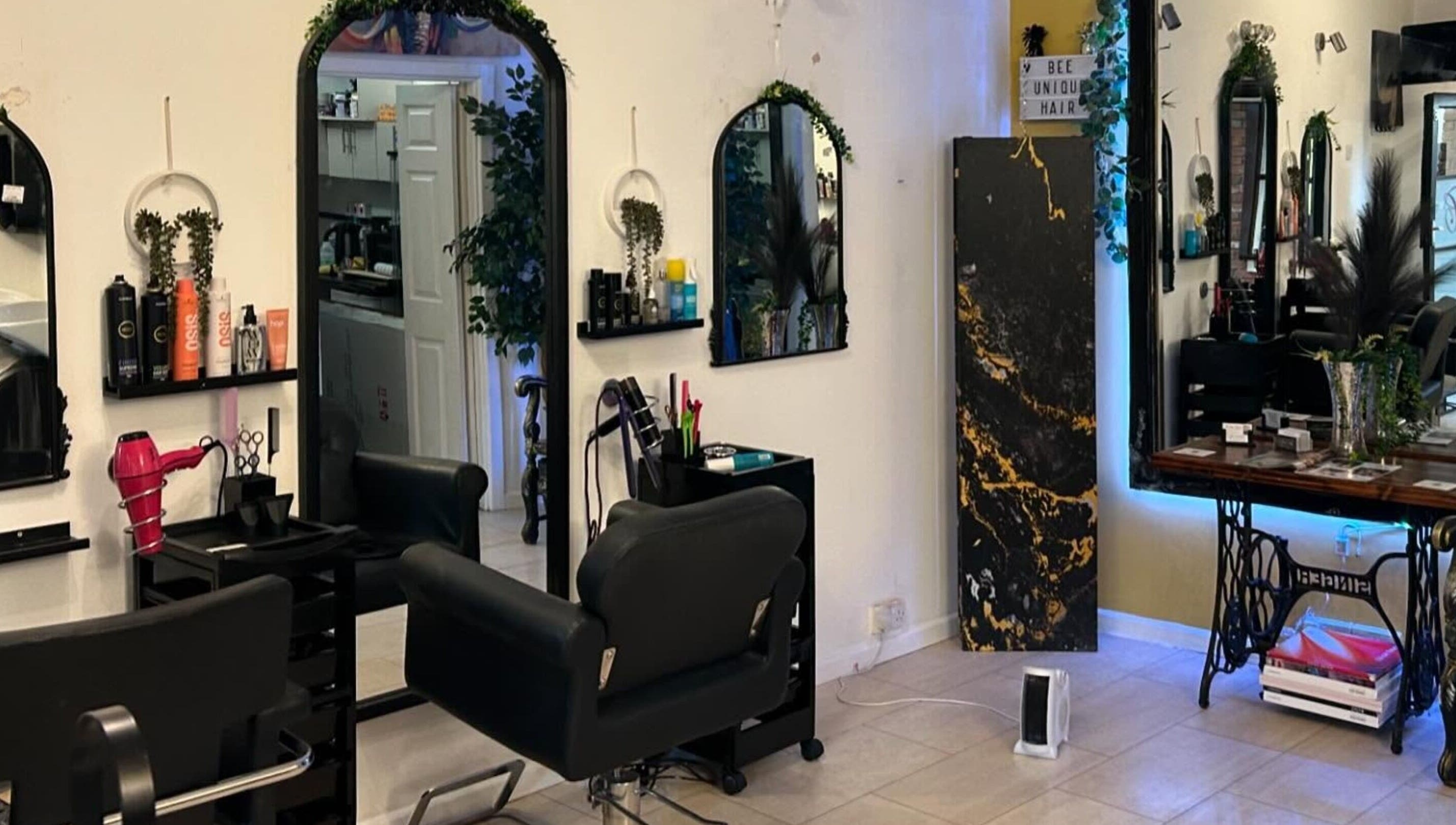 BeeUnique salon interior in Northampton, England, GB with stylish seating and modern haircare products.