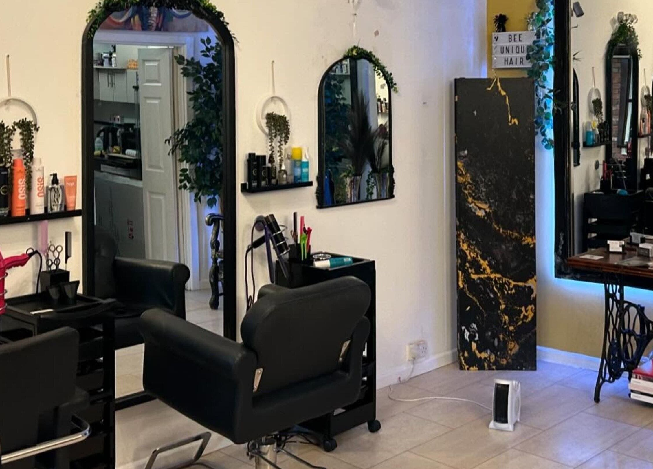 BeeUnique salon interior in Northampton, England, GB with stylish seating and modern haircare products.