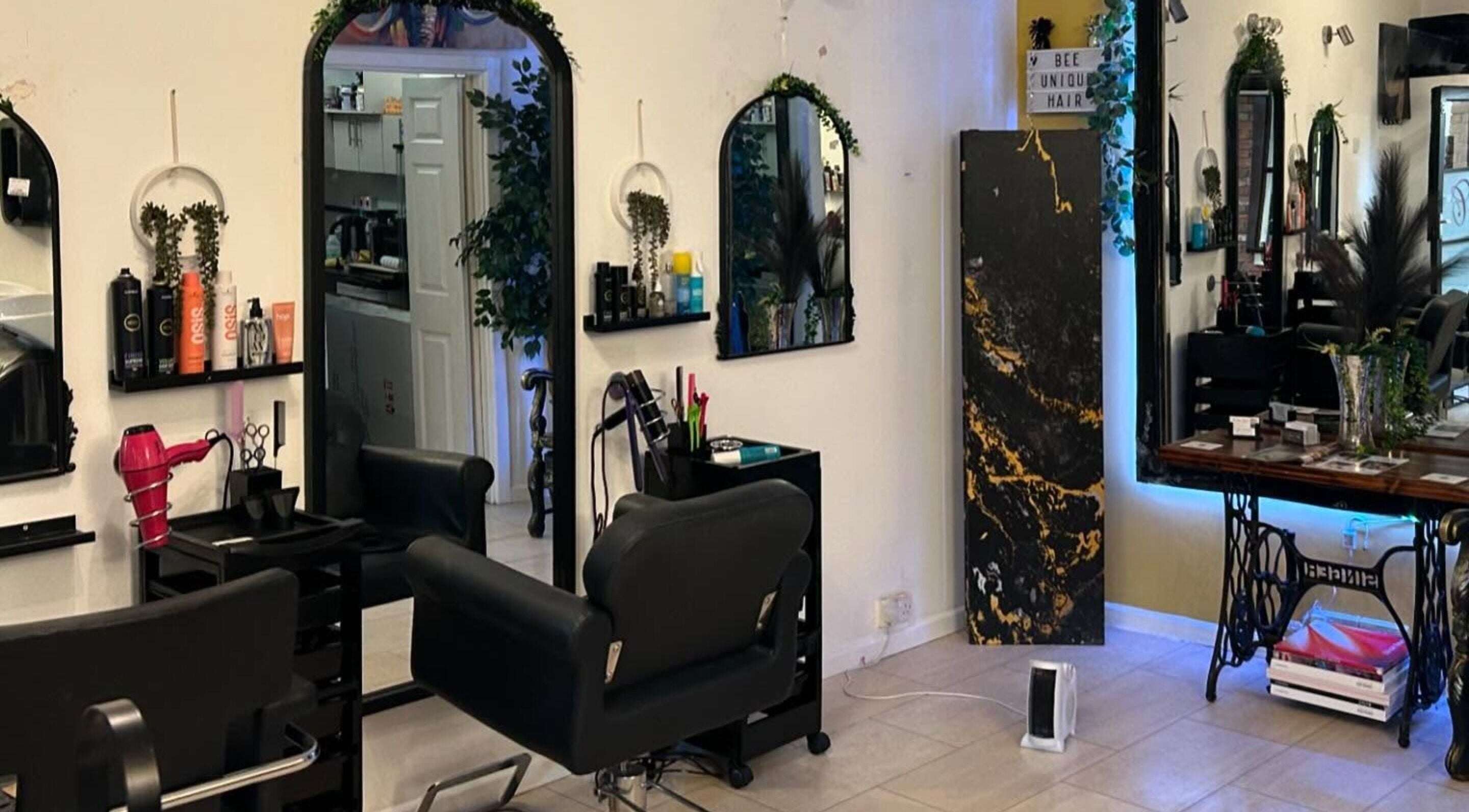 BeeUnique salon interior in Northampton, England, GB with stylish seating and modern haircare products.