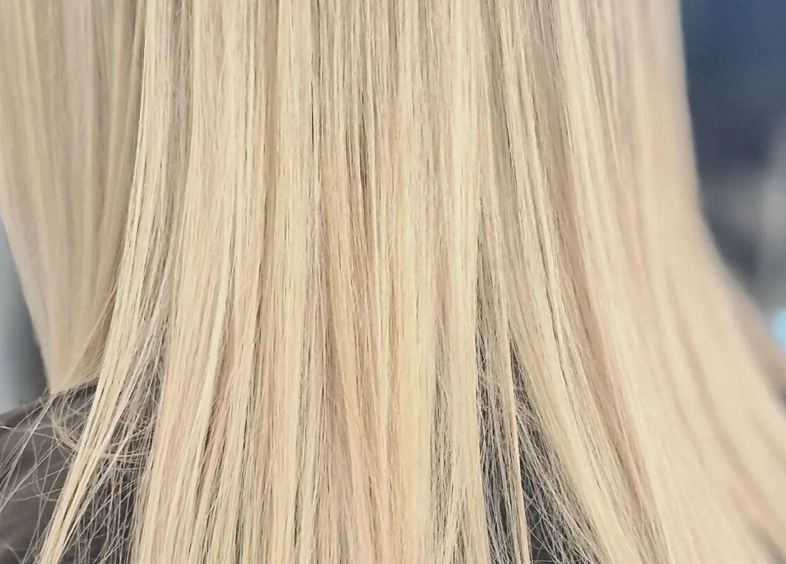 Sleek blonde hair at BeeUnique, Northampton, England, GB, showcasing professional hair styling.