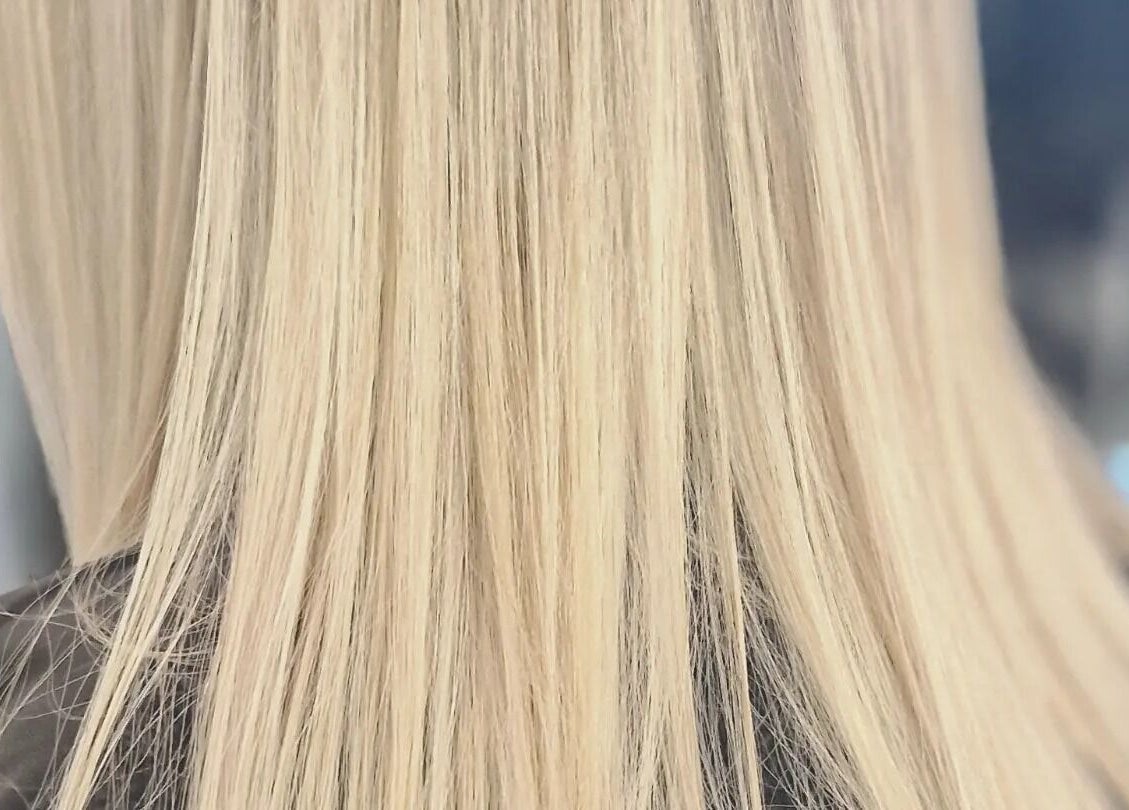 Sleek blonde hair at BeeUnique, Northampton, England, GB, showcasing professional hair styling.