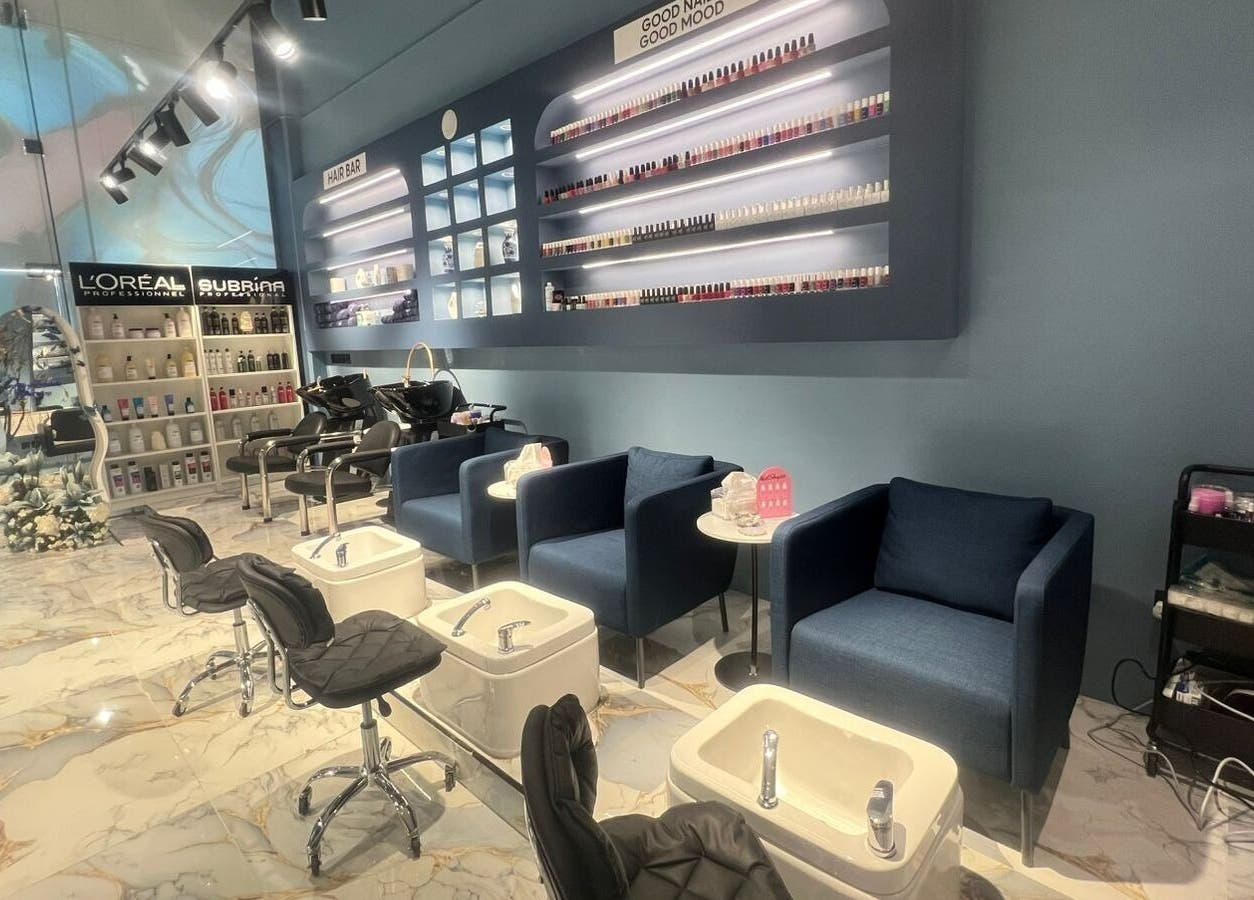 Elegant interior of 3 Papillons Salon in Dammam, Eastern Province, SA showcasing manicure stations and product displays.