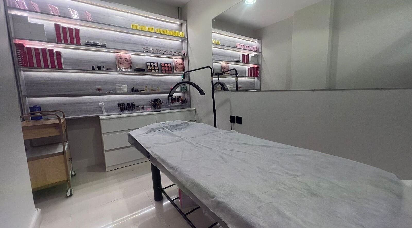 Luxurious treatment room at 3 Papillons Salon, Dammam, Eastern Province, SA, featuring modern decor and beauty products.