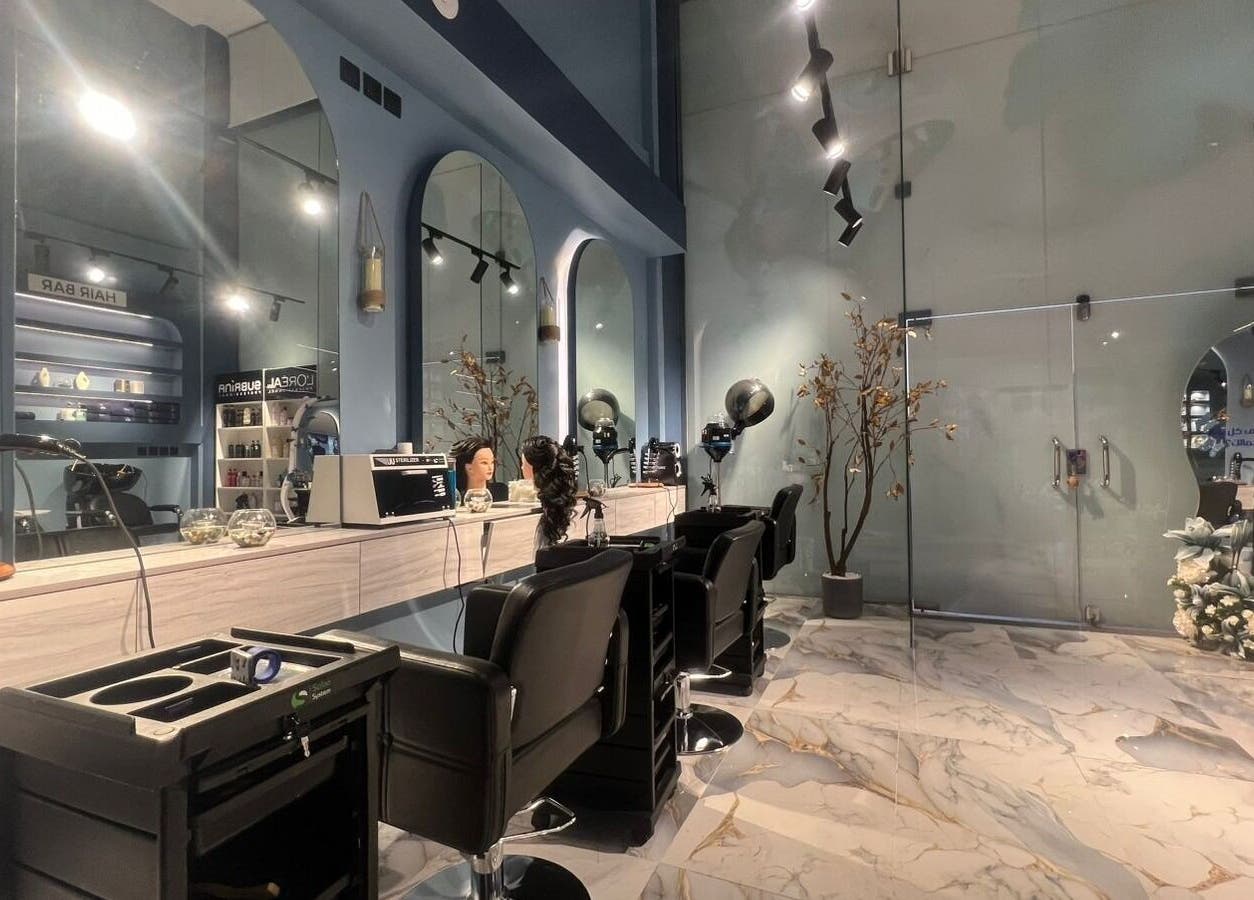 Chic interior of 3 Papillons Salon in Dammam, Eastern Province, SA featuring sleek styling stations and modern decor.