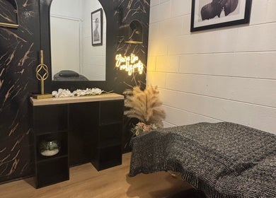 Elegant massage room at The Allure Body Contouring, Adelaide, South Australia, AU with cozy decor and ambient lighting.