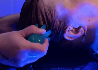 Relaxing head massage at The Allure Body Contouring in Adelaide, South Australia, AU under calming blue light.