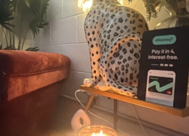 The Allure Body Contouring, Adelaide SA, cozy seating with leopard decor and candle light atmosphere.